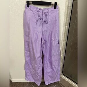 A pair of poplin cargo joggers featuring a toggle drawstring mid-rise waist